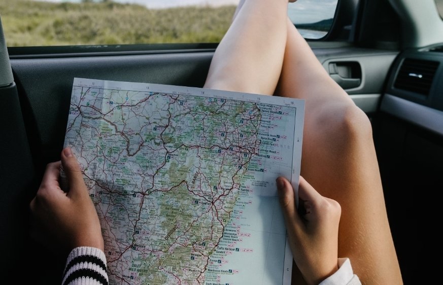 Girl in car with a map